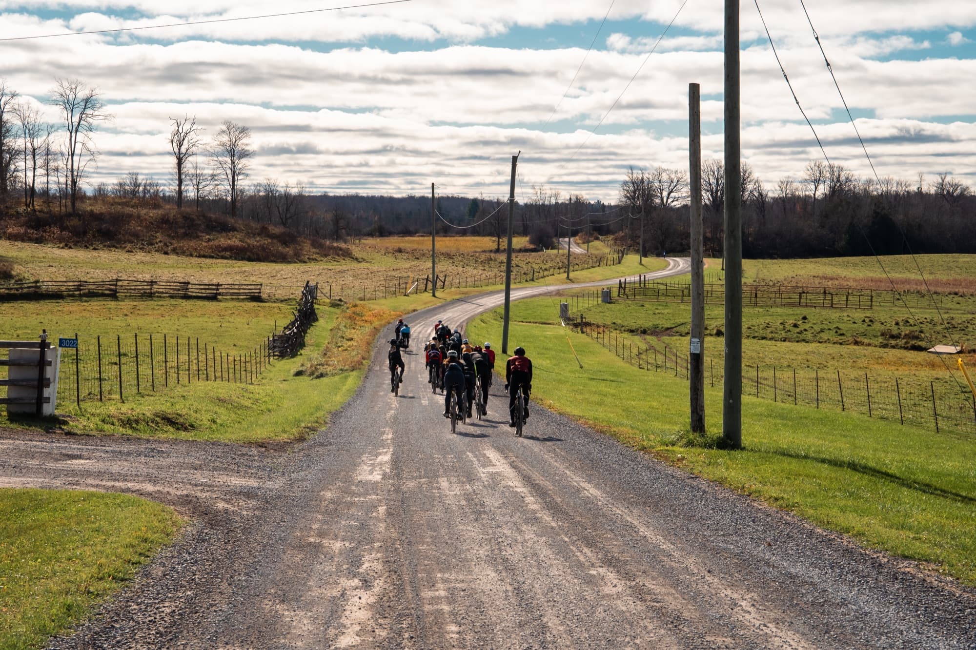 A long line of riders climbing a gravel road at the Candy Burner