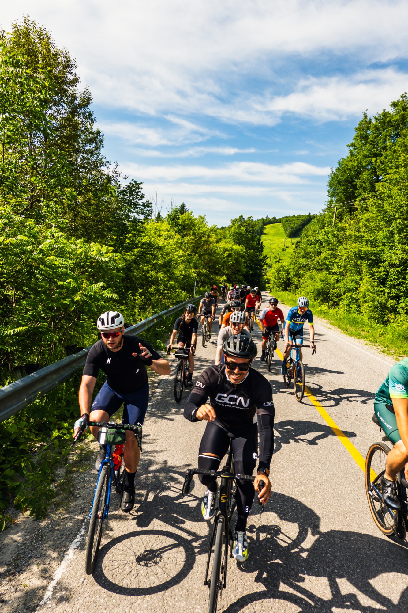 The bunch pours down the hill, each rider holding a line